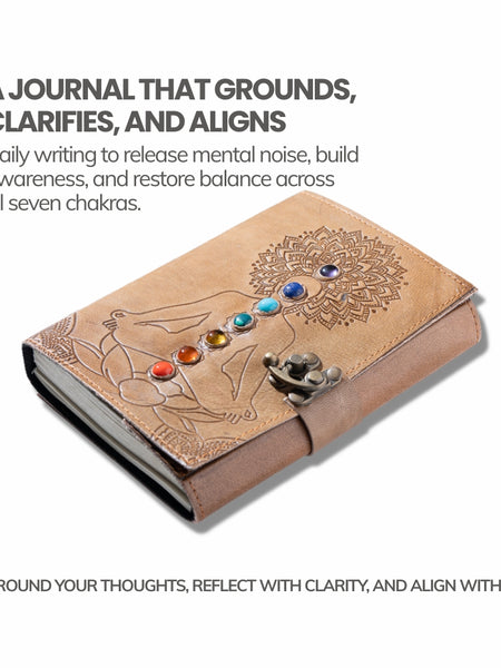 Brown leather journal with chakra stones and mandala design on a white background