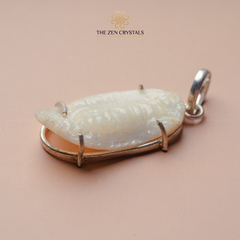 Shukra Mani pendant with gold frame on a beige background, branded 'The Zen Crystals'.