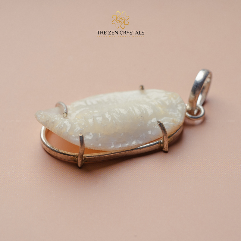 Shukra Mani pendant with gold frame on a beige background, branded 'The Zen Crystals'.