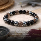 Safe Travel Energy Bracelet Black obsidian, hematite, and smoky quartz bracelet with travel-themed items on a wooden surface.