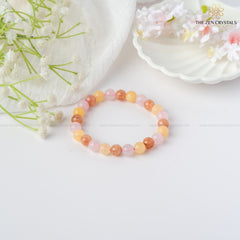 happiness and tranquility bracelet  on a white surface with floral elements, branded 'The Zen Crystals'.