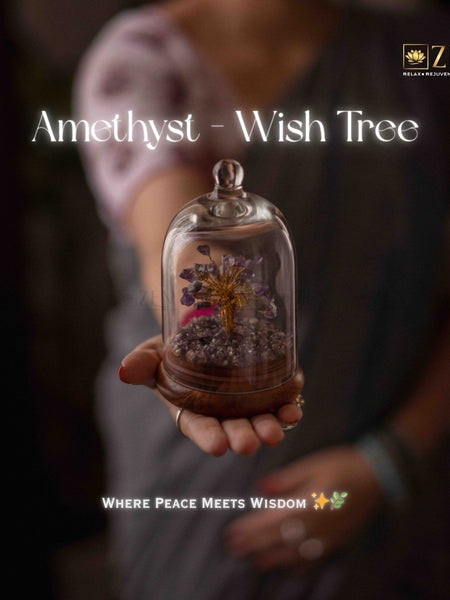 Person holding a glass dome with an amethyst wish tree and 'ZEN' branding.