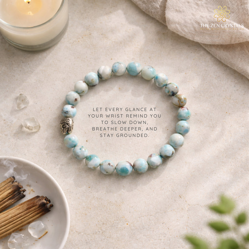 larimar bracelet with inspirational quote on a neutral background, surrounded by crystals and incense.