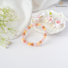 happiness and tranquility bracelet on a white surface with flowers and 'The Zen Crystals' branding.