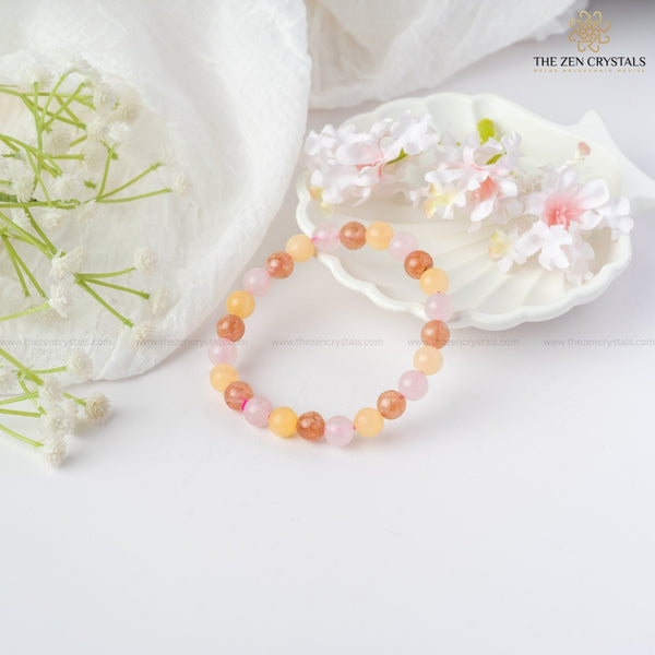happiness and tranquility bracelet on a white surface with flowers and 'The Zen Crystals' branding.