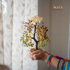 Person holding a decorative tree with a blurred background