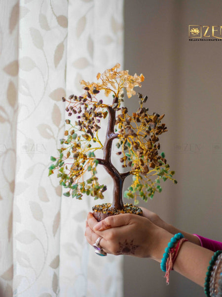 Person holding a decorative tree with a blurred background