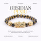 Black obsidian Pi Xiu bracelet with gold accents on a white background