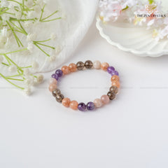 calm & peace energy bracelet on a white surface with flowers and 'The Zen Crystals' branding.
