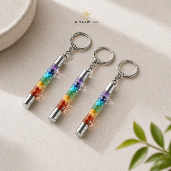 7 CHAKRA SLIMTUBE keychains on a beige surface with 'The Zen Crystals' branding.