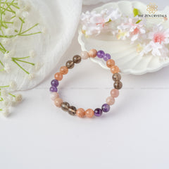 calm & peace energy bracelet on a white surface with flowers and a shell in the background, branded 'The Zen Crystals'.