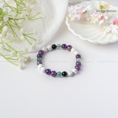 clarity of thoughts bracelet on a white surface with flowers and 'The Zen Crystals' branding.