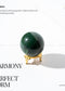 Green jade sphere on a gold stand with text about balance, growth, and calm energy.