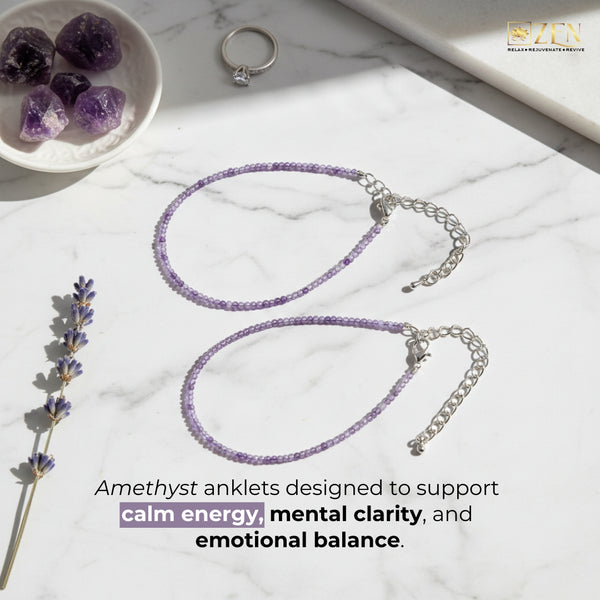 Amethyst anklets on a marble surface with crystals and a bowl.