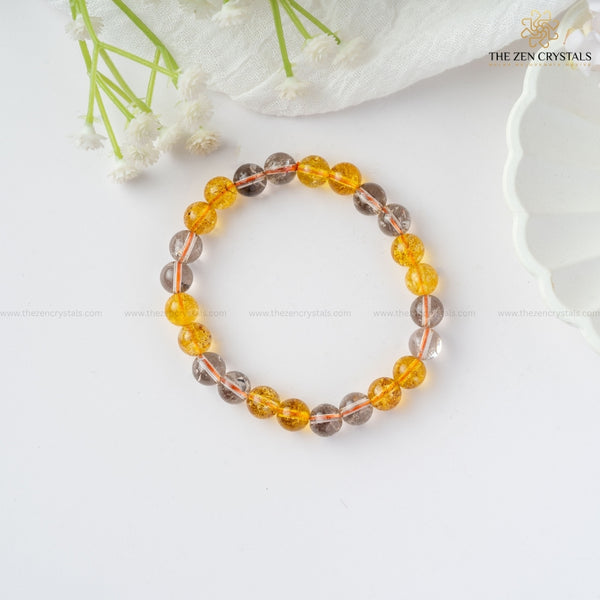 Success & Protection Energy Bracelet with yellow and gray beads on a white background, featuring 'The Zen Crystals' brand.