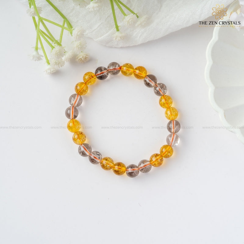 Success & Protection Energy Bracelet with yellow and gray beads on a white background, featuring 'The Zen Crystals' brand.