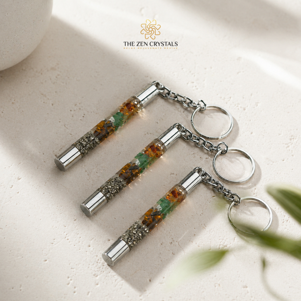 money magnet slimtube keychains on a light surface with 'The Zen Crystals' branding.
