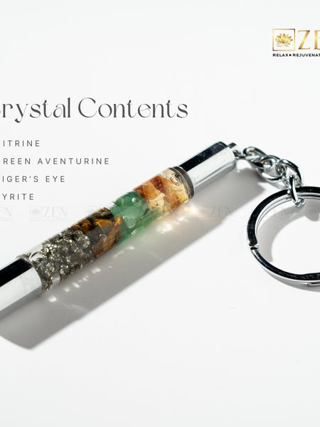 Money Magnet Crystal keychain with visible stones on a white background, featuring the brand 'Zen'.