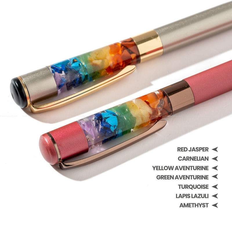 Two pens with colorful gemstone inlays on a white background