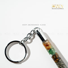 Keychain with multicolored chips on a white background, featuring the brand 'Zen'.
