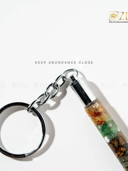 Keychain with multicolored chips on a white background, featuring the brand 'Zen'.