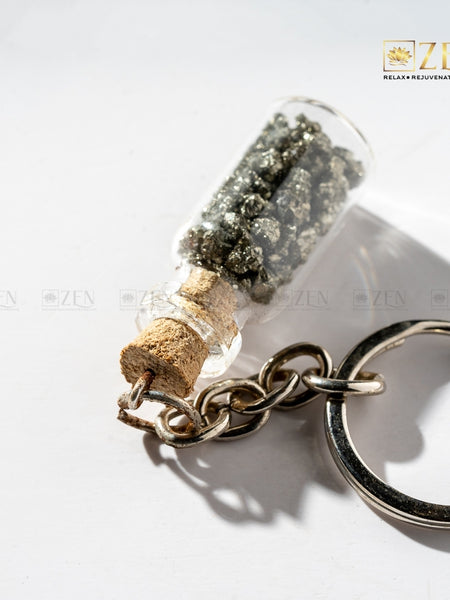 Close-up of Pyrite Treasure Bottle Keychain showing golden pyrite stones inside glass bottle charm