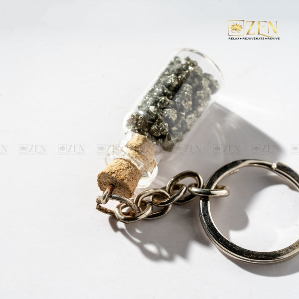 Close-up of Pyrite Treasure Bottle Keychain showing golden pyrite stones inside glass bottle charm