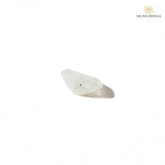 side view of moonstone crystal on a white background