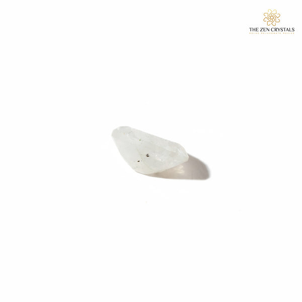 side view of moonstone crystal on a white background