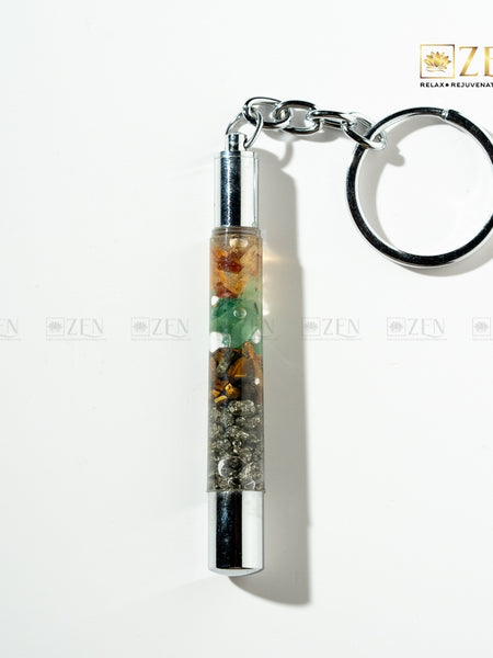Money Magnet Keychain with a cylindrical container filled with colorful stones on a white background, featuring the 'Zen' brand.