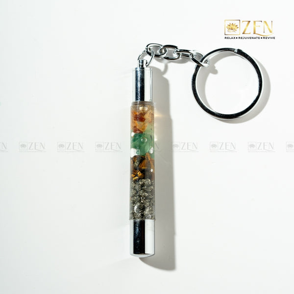 Money Magnet Keychain with a cylindrical container filled with colorful stones on a white background, featuring the 'Zen' brand.