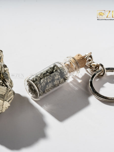 Rustic treasure bottle-shaped keychain filled with pyrite crystals, perfect for everyday carry