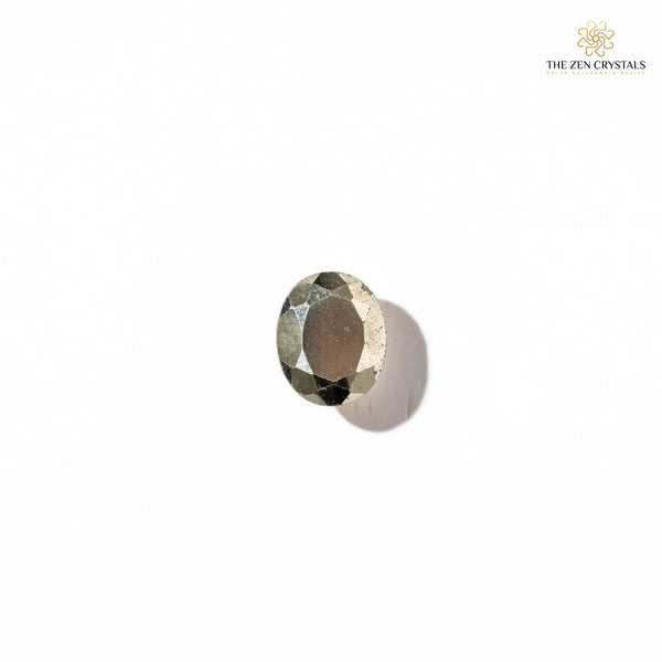 Faceted pyrite gemstone on a white background with 'The Zen Crystals' logo.