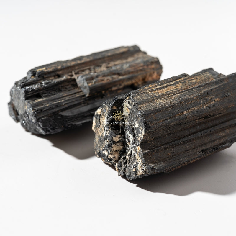 Two pieces of black tourmaline on a white background with 'The Zen Company' logo.