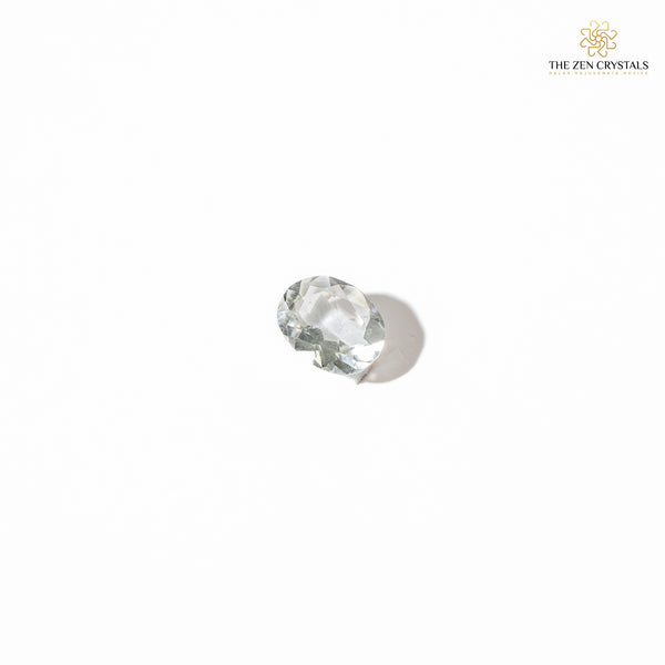 clear quartz crystal on a white background, branded 'The Zen Crystals'.