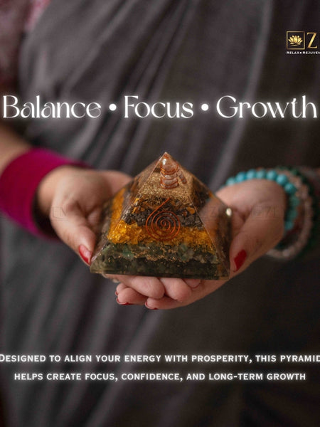 Person holding a money magnet pyramid stone with 'Balance, Focus, Growth' text and ZEN logo.