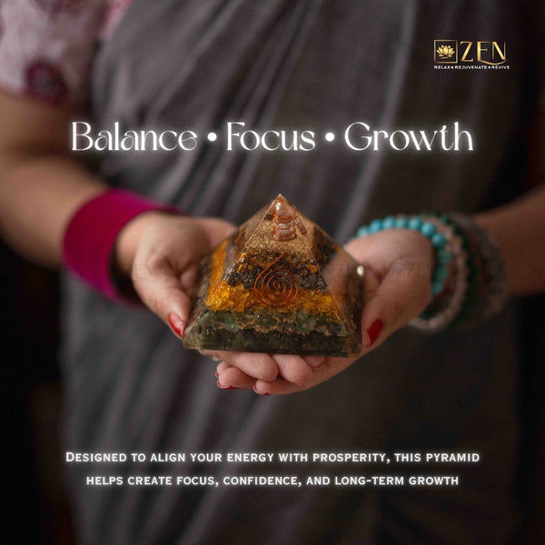Person holding a money magnet pyramid stone with 'Balance, Focus, Growth' text and ZEN logo.