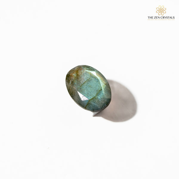 Green labradorite stone on a white background with 'The Zen Crystals' logo.