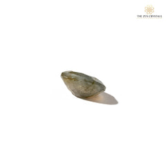 labradorite stone with a soft glow on a white background, branded 'The Zen Crystals'.