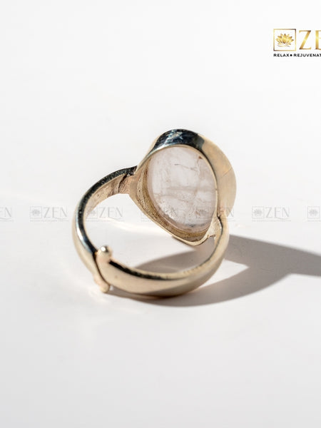 Silver ring with rose quartz on a white background, featuring the brand 'Zen'.