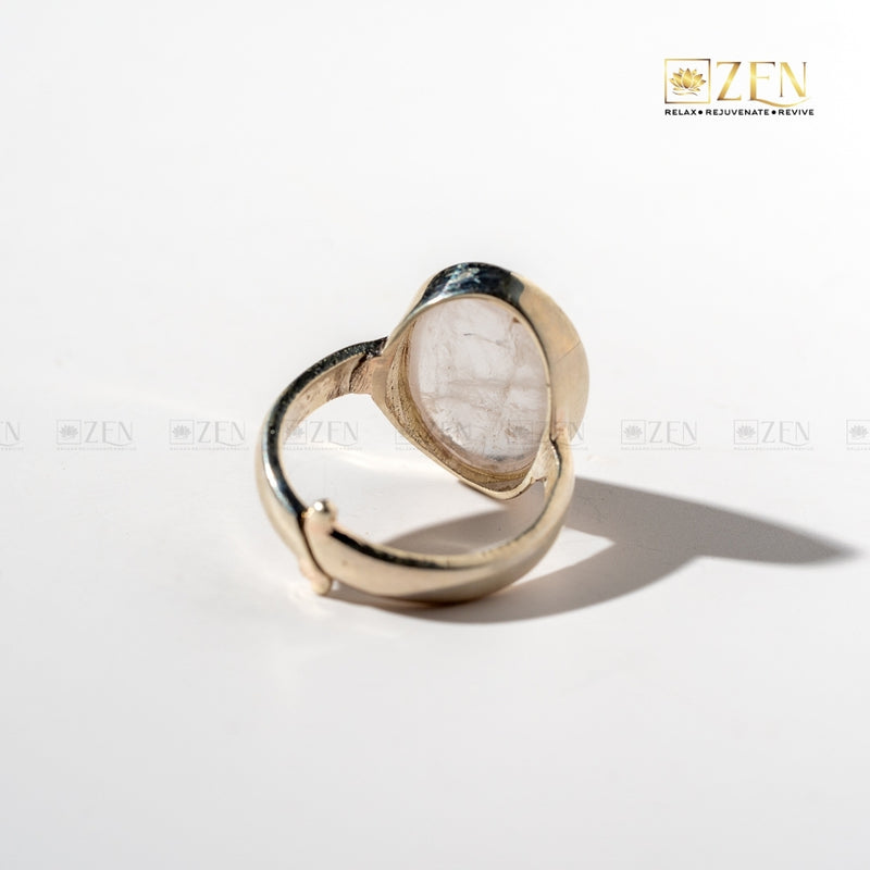 Silver ring with rose quartz on a white background, featuring the brand 'Zen'.