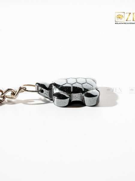 Close-up of The Zen Crystals’ Hematite Turtle Keychain made from natural Hematite stone for grounding and protection.