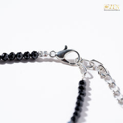 Close-up of a black obsidian anklet adjustable hook