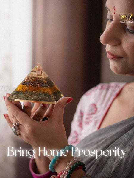 Woman holding a pyramid-shaped object with 'Zen' brand logo and text 'Bring Home Prosperity'.
