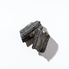 Two black tourmaline on a white background with 'The Zen Crystals' logo.