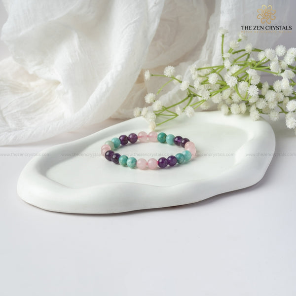 Relaxation Energy Bracelet on a white dish with white flowers and 'The Zen Crystals' branding.