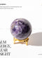Amethyst sphere on a gold stand with text about its properties and benefits.