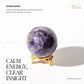 Amethyst sphere on a gold stand with text about its properties and benefits.