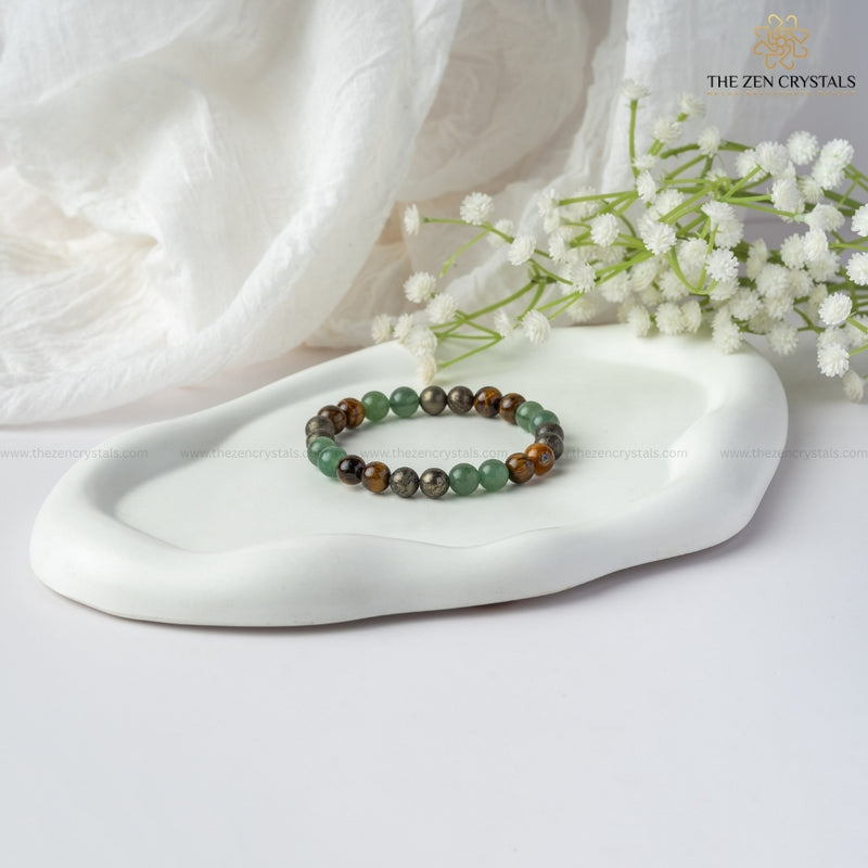 Business Success Energy Bracelet on a white dish with white flowers and 'The Zen Crystals' branding.