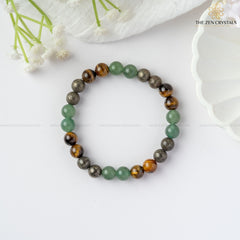 Business Success Energy Bracelet on a white surface with flowers in the background, branded 'The Zen Crystals'.